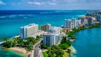 Hotels and high-rises on the coast, and crystal blue water, San Juan, Puerto Rico  Aerial Stock Photos | AX102_002.0000000F