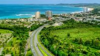 Beachside community and condos by crystal blue waters, Luquillo, Puerto Rico Aerial Stock Photos | AX102_049.0000000F