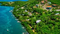 Oceanfront homes and docks along the coast and sapphire waters, Culebra, Puerto Rico Aerial Stock Photos | AX102_157.0000125F