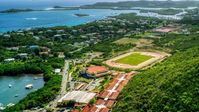 Island high school and track field near waterfront homes in East End, St Thomas, US Virgin Islands   Aerial Stock Photos | AX102_244.0000000F