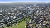 A wide view of River Clyde and bridges near city buildings in Glasgow, Scotland Aerial Stock Photos | AX110_163.0000000F