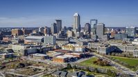 The city's skyline in Downtown Indianapolis, Indiana seen from smaller brick buildings Aerial Stock Photos | DXP001_090_0005