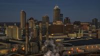 Smoke stacks and a view of city skyline at twilight in Downtown Indianapolis, Indiana Aerial Stock Photos | DXP001_093_0001