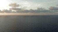 HD stock footage aerial video of flying between cloud and open sea at sunrise in the Gulf of Mexico Aerial Stock Footage | AF0001_000351