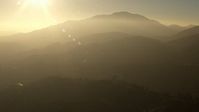 HD stock footage aerial video approach the hazy San Gabriel Mountains, California, sunset Aerial Stock Footage | AF0001_000509