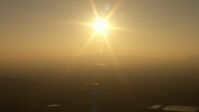 HD stock footage aerial video of setting sun over distant hills in San Fernando Valley, California, sunset Aerial Stock Footage | AF0001_000519