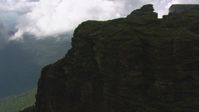 HD stock footage aerial video tilt from jungle to reveal steep mountain cliffs in the Guiana Highlands, Southern Venezuela Aerial Stock Footage | AF0001_000592