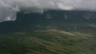 HD stock footage aerial video zoom in on steep mountain slopes and jungle beneath clouds in Southern Venezuela Aerial Stock Footage | AF0001_000616