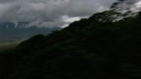 HD stock footage aerial video zoom wider to a view of dense clouds, hilly savanna, reveal jungle and mountains in Southern Venezuela Aerial Stock Footage | AF0001_000622