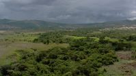 HD stock footage aerial video of a reverse view of green mountains and a small rural town in Southern Venezuela Aerial Stock Footage | AF0001_000639