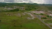 HD stock footage aerial video approach a small town by a country highway in Southern Venezuela Aerial Stock Footage | AF0001_000676