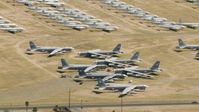 HD stock footage aerial video flying by bomber jets at an aircraft boneyard, Davis Monthan AFB, Tucson, Arizona Aerial Stock Footage | AF0001_000857