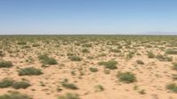 HD stock footage aerial video of passing desert vegetation on a wide desert plain in New Mexico Aerial Stock Footage | AF0001_000905