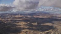 8K stock footage aerial video fly over desert hills beneath clouds in Southern California Aerial Stock Footage | AF0001_001020
