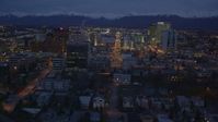 4K stock footage aerial video revealing Hotel Captain Cook, Downtown Anchorage, Alaska, night Aerial Stock Footage | AK0001_0156