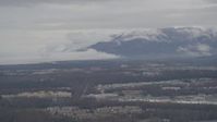 4K stock footage aerial video flying by neighborhoods, Chugach Mountains in the distance, Anchorage, Alaska Aerial Stock Footage | AK0001_0337