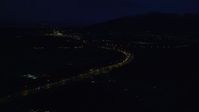 4K stock footage aerial video flying over Glenn Highway, approach Chugach Mountains, Anchorage, Alaska, night Aerial Stock Footage | AK0001_0603