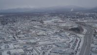 4K stock footage aerial video following Glenn Highway through snow covered Anchorage, Alaska Aerial Stock Footage | AK0001_1148