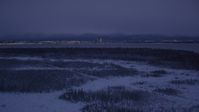 4K stock footage aerial video Downtown Anchorage skyline, snowy ground, Point MacKenzie, Alaska, night Aerial Stock Footage | AK0001_1717