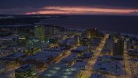 4K stock footage aerial video flying over snow covered Downtown Anchorage at night, Alaska Aerial Stock Footage | AK0001_1726