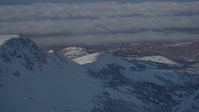 4K stock footage aerial video cloud covered Anchorage, seen from snow covered Chugach Mountains, Alaska Aerial Stock Footage | AK0001_1997