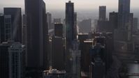 4.8K stock footage aerial video flying by downtown Chicago skyscrapers, revealing Jay Pritzker Pavilion, on a hazy day, Illinois Aerial Stock Footage | AX0001_094