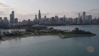 4.8K stock footage aerial video of the Downtown Chicago skyline seen while flying by Adler Planetarium, Illinois Aerial Stock Footage | AX0002_088