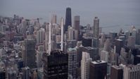 4.8K stock footage aerial video approach spires atop Willis Tower with a view of the cityscape of Downtown Chicago at sunset, Illinois Aerial Stock Footage | AX0003_045