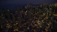 4.8K stock footage aerial video tilt up and approach Downtown Chicago skyscrapers and high-rises at night, Illinois Aerial Stock Footage | AX0003_141
