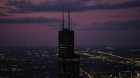 4.8K stock footage aerial video of orbiting the top of Willis Tower, on a cloudy day at night, Downtown Chicago, Illinois Aerial Stock Footage | AX0003_149