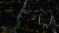5K stock footage aerial video pan across streets and skyscrapers at night in Downtown Los Angeles, California Aerial Stock Footage | AX0004_055