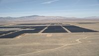 5K stock footage aerial video of a reverse view of a solar energy farm in the Mojave Desert, California Aerial Stock Footage | AX0005_094