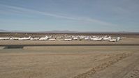 5K stock footage aerial video of a low altitude orbit of planes at an aircraft boneyard in the desert, Mojave Air and Space Port, California Aerial Stock Footage | AX0006_057