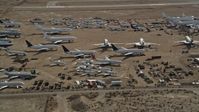 5K stock footage aerial video orbiting jet aircraft at an airplane boneyard in the Mojave Desert, California Aerial Stock Footage | AX0006_063