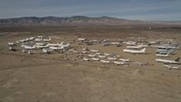 5K stock footage aerial video orbit airplanes in a desert field at an aircraft boneyard, Mojave Air and Space Port, California Aerial Stock Footage | AX0006_069
