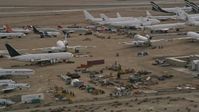 5K stock footage aerial video orbit aircraft and components at a desert boneyard in California, Mojave Air and Space Port Aerial Stock Footage | AX0006_075