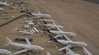 5K stock footage aerial video approach group of jet airplanes at a boneyard in the desert, Mojave Air and Space Port, California Aerial Stock Footage | AX0006_087E
