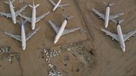 5K stock footage aerial video bird's eye view of a group of airplanes at a boneyard in the desert, Mojave Air and Space Port, California Aerial Stock Footage | AX0006_090