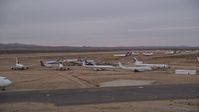 5K stock footage aerial video of low altitude orbit around airliners at the Victorville Airport boneyard in California at Sunset Aerial Stock Footage | AX0007_003E
