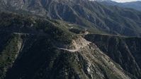5K stock footage aerial video descend toward a road in the San Gabriel Mountains, California Aerial Stock Footage | AX0009_037