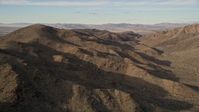 5K stock footage aerial video of flying along desert mountains, Mojave Desert, California Aerial Stock Footage | AX0011_051