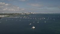 5K stock footage aerial video fly over bay and tilt to reveal sailboats and Downtown Miami skyline, Florida Aerial Stock Footage | AX0020_001