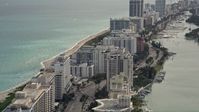 5K stock footage aerial video fly over beachfront condominiums on Collins Avenue in Miami Beach, Florida Aerial Stock Footage | AX0021_025E