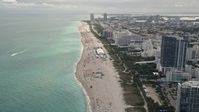 5K stock footage aerial video fly over beach to approach hotels and condominiums with ocean views in Miami Beach, Florida Aerial Stock Footage | AX0021_035E