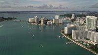 5K stock footage aerial video flyby waterfront South Beach condos and hotels to approach Belle Island, Florida Aerial Stock Footage | AX0021_065E
