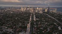 5K stock footage aerial video of following SW 3rd Avenue through suburbs to approach Downtown Miami at sunset, Florida Aerial Stock Footage | AX0022_024