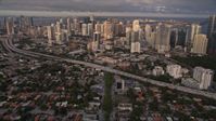 5K stock footage aerial video tilt from SW 3rd Avenue to reveal skyscrapers in Downtown Miami at sunset, Florida Aerial Stock Footage | AX0022_026E