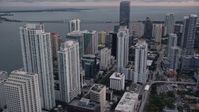 5K stock footage aerial video of skyscrapers by the shore of the bay in Downtown Miami at sunset, Florida Aerial Stock Footage | AX0022_067E