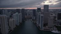 5K stock footage aerial video of Miami River and riverfront skyscrapers at sunset in Downtown Miami, Florida Aerial Stock Footage | AX0022_083E