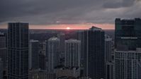 5K stock footage aerial video of setting sun behind tall skyscrapers in Downtown Miami, Florida Aerial Stock Footage | AX0022_085E
